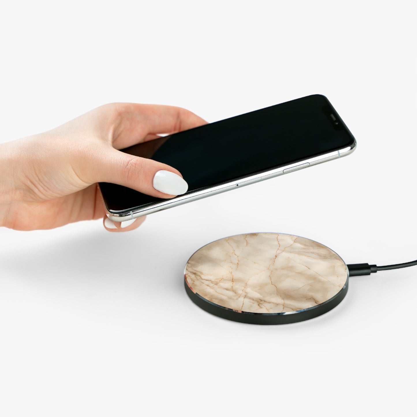 Hand placing smartphone on Parchment Mist beige marble design Qi wireless charger