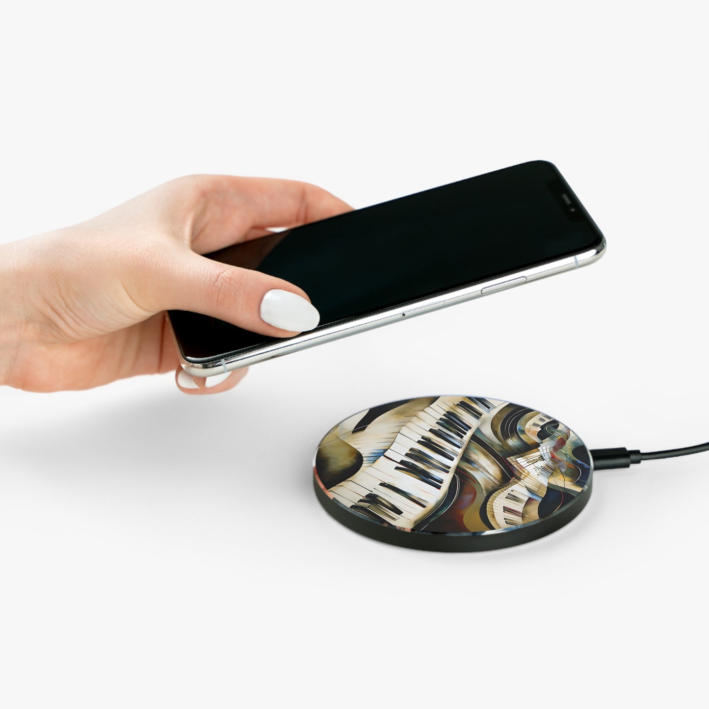 Hand placing smartphone on Ivory Cascade piano keyboard design Qi wireless charger