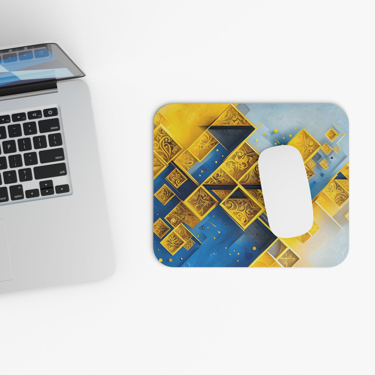 Golden Ascent mouse pad beside laptop displaying gold geometric artwork