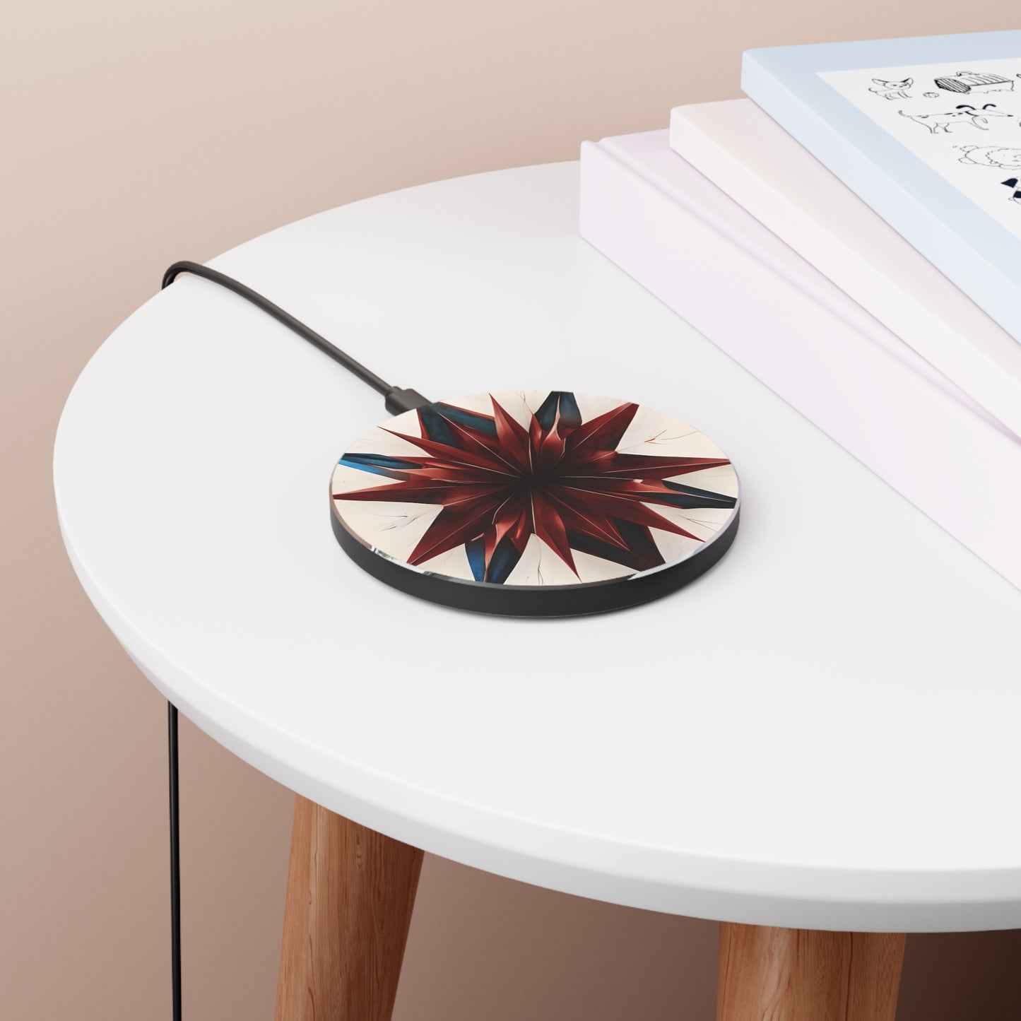 Garnet Starburst red, white and blue geometric art Qi wireless charger on bedside table with books