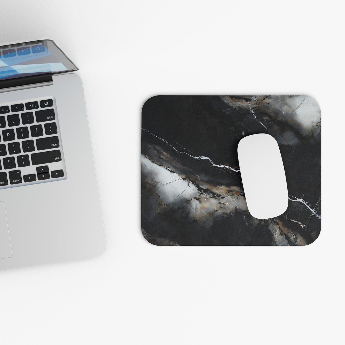 Obsidian Vein mouse pad beside laptop displaying black marble design
