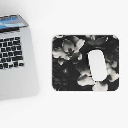 Monochrome Magnolia mouse pad beside laptop displaying black and white floral artwork