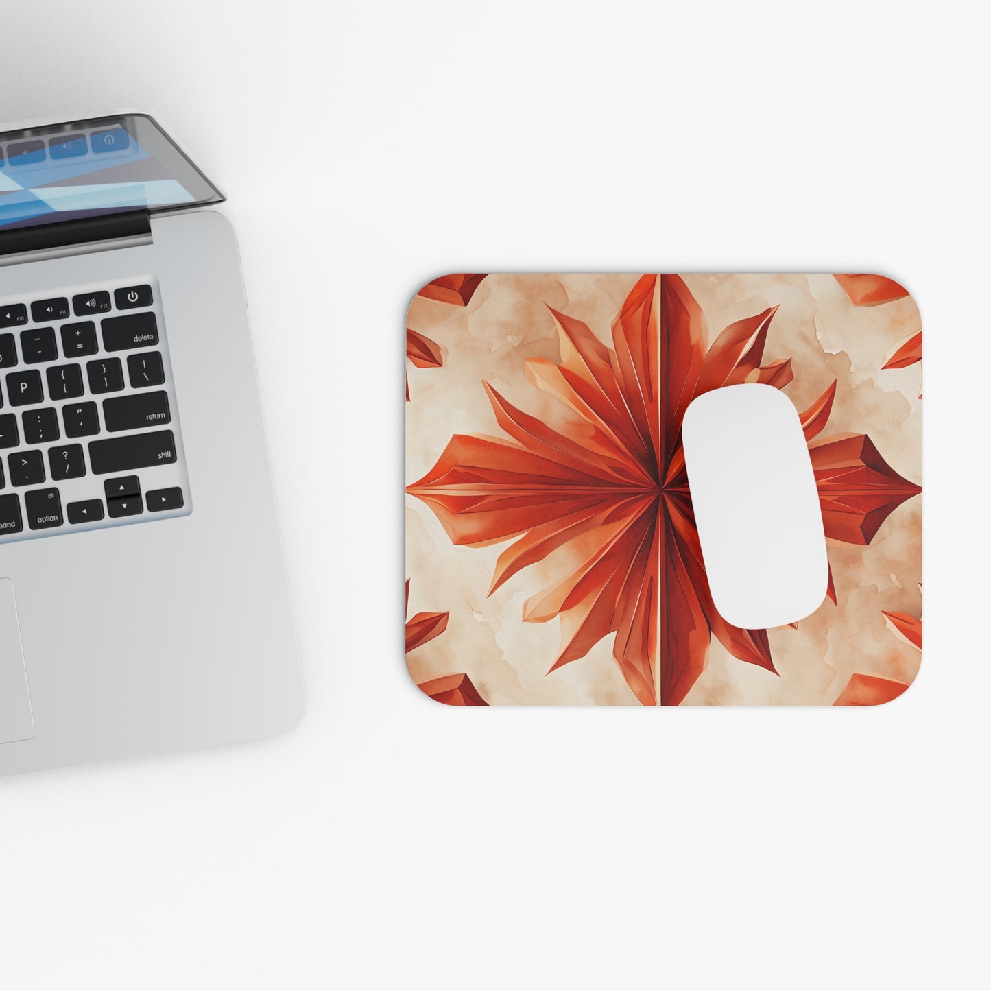 Sunset Fleur mouse pad beside laptop displaying sunset floral design