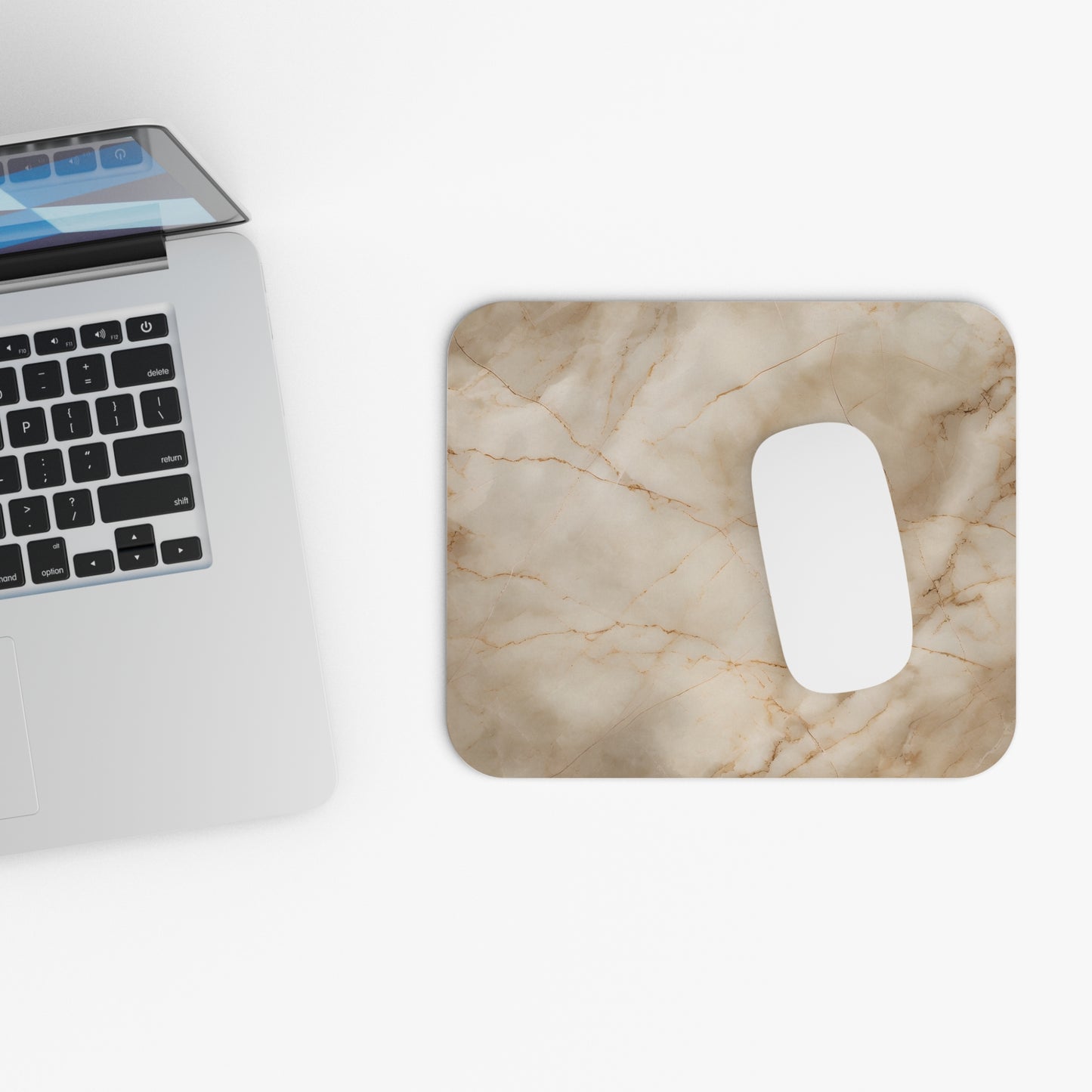 Parchment Mist mouse pad beside laptop displaying neutral marble design