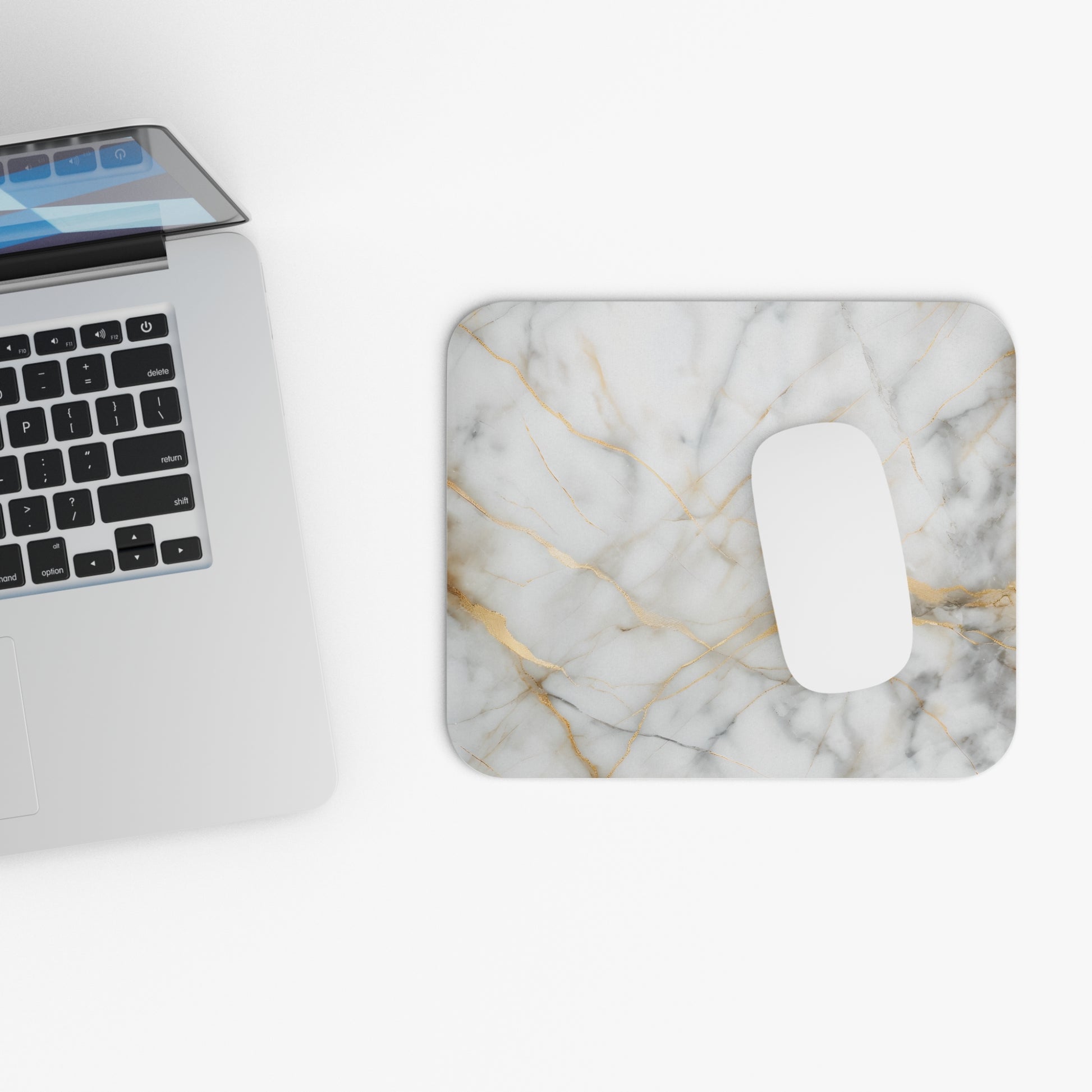 Golden Vein Marble mouse pad beside laptop displaying marble vein design