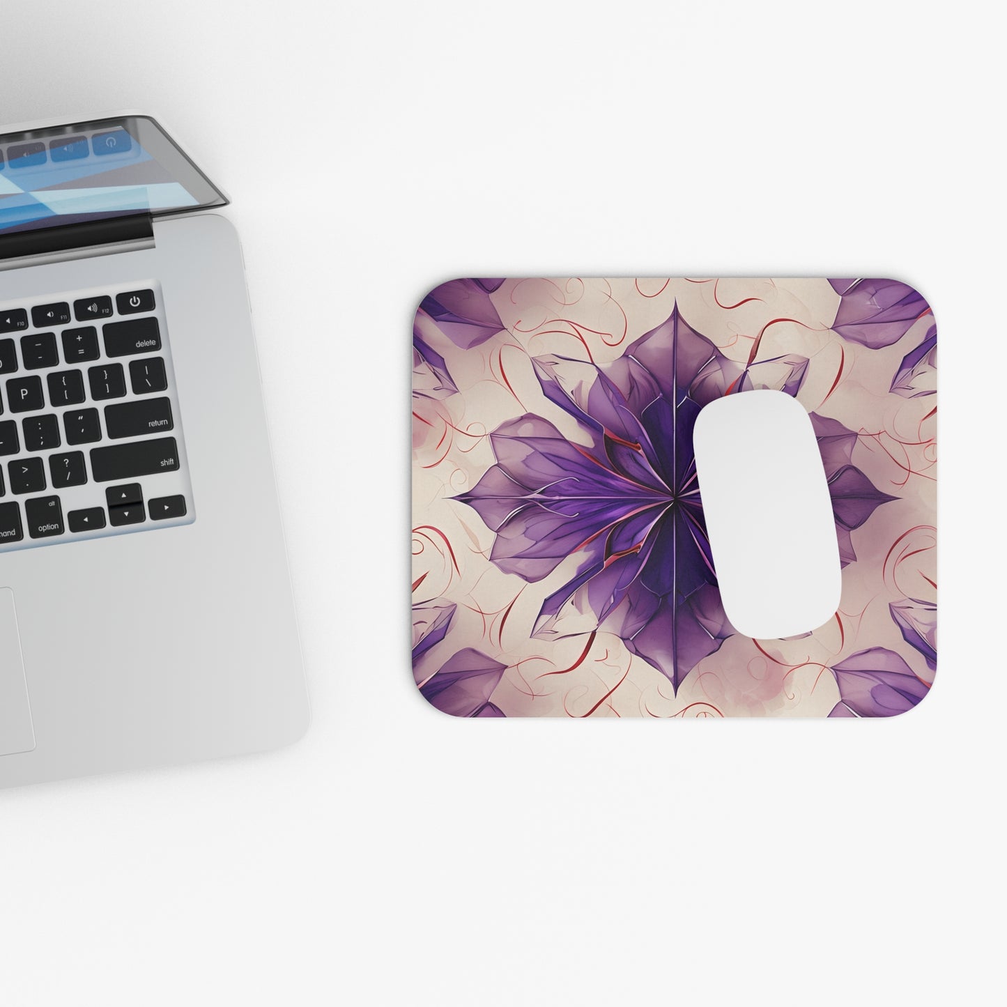 Violet Reverie mouse pad beside laptop displaying violet floral artwork