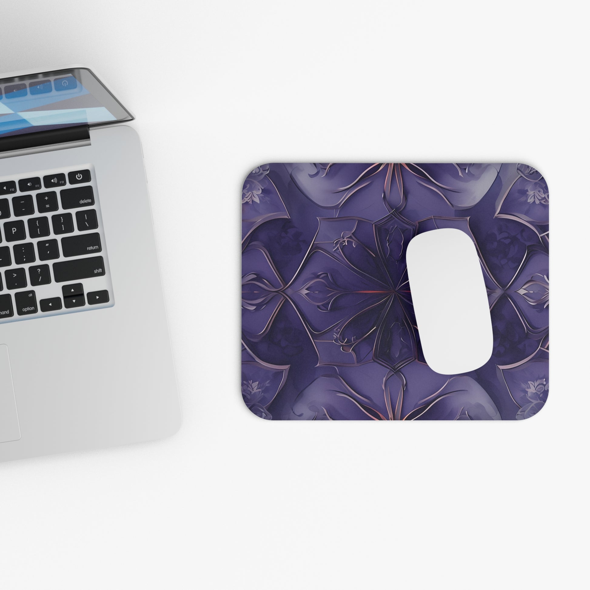 Violet Nebula mouse pad beside laptop displaying violet abstract floral design