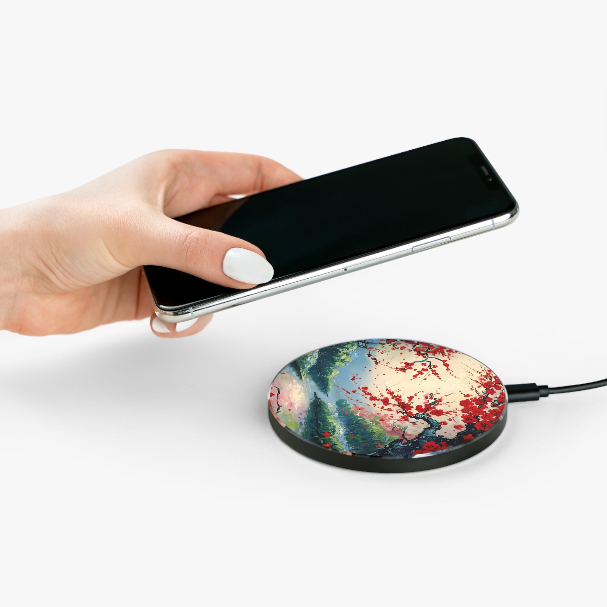 Hand placing smartphone on Crimson Blossom Lake red blossom landscape design Qi wireless charger