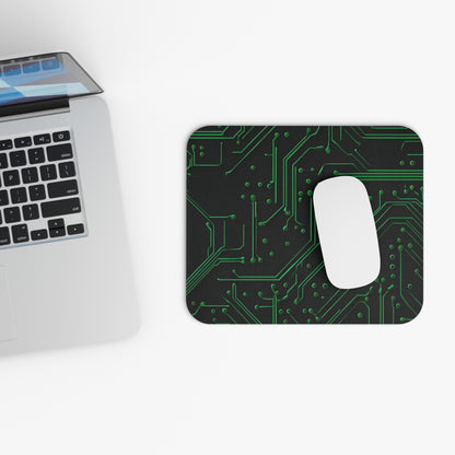 Green Circuit Grid mouse pad beside laptop displaying green circuit board artwork