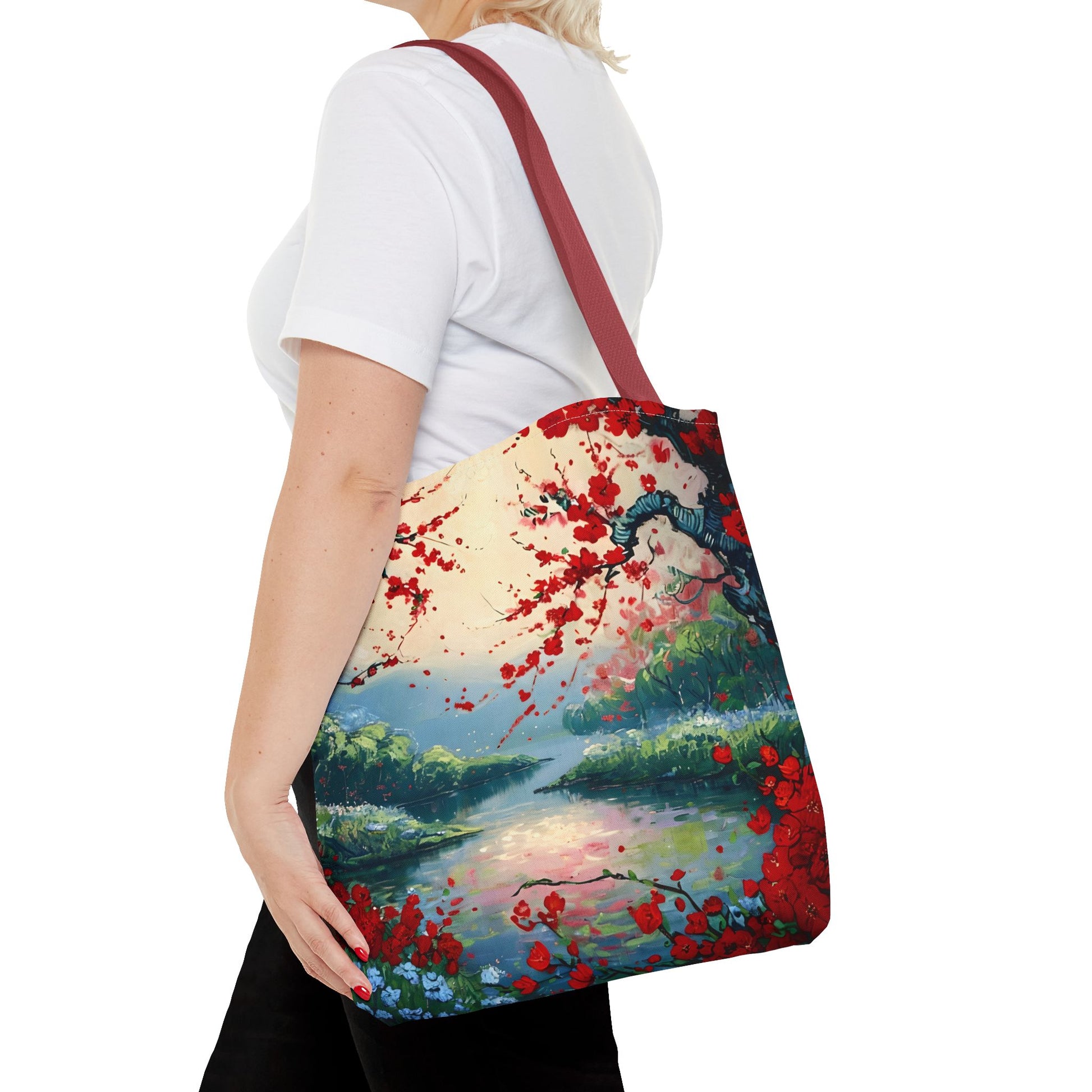Crimson Blossom Lake canvas tote bag worn over shoulder showing scenic blossom lake design