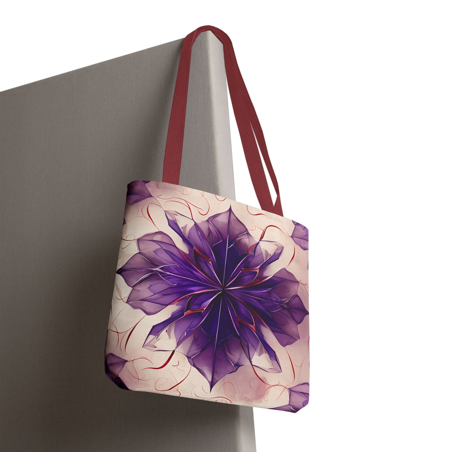 Violet Reverie canvas tote bag hanging with expressive purple floral design and red handles