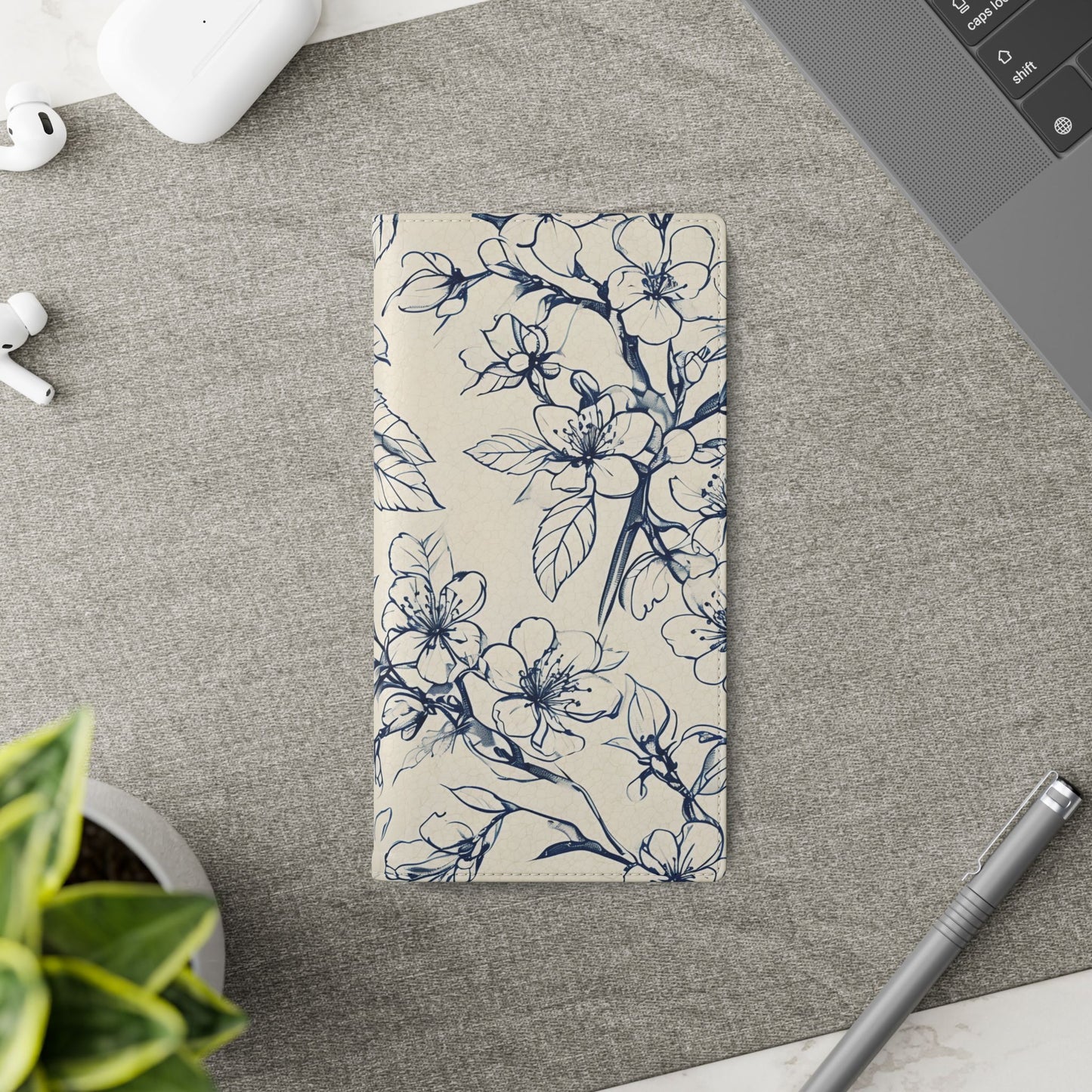 Blossom Sketch Samsung Galaxy wallet flip phone case on a desk beside stationery featuring navy botanical floral sketch design and folio card holder