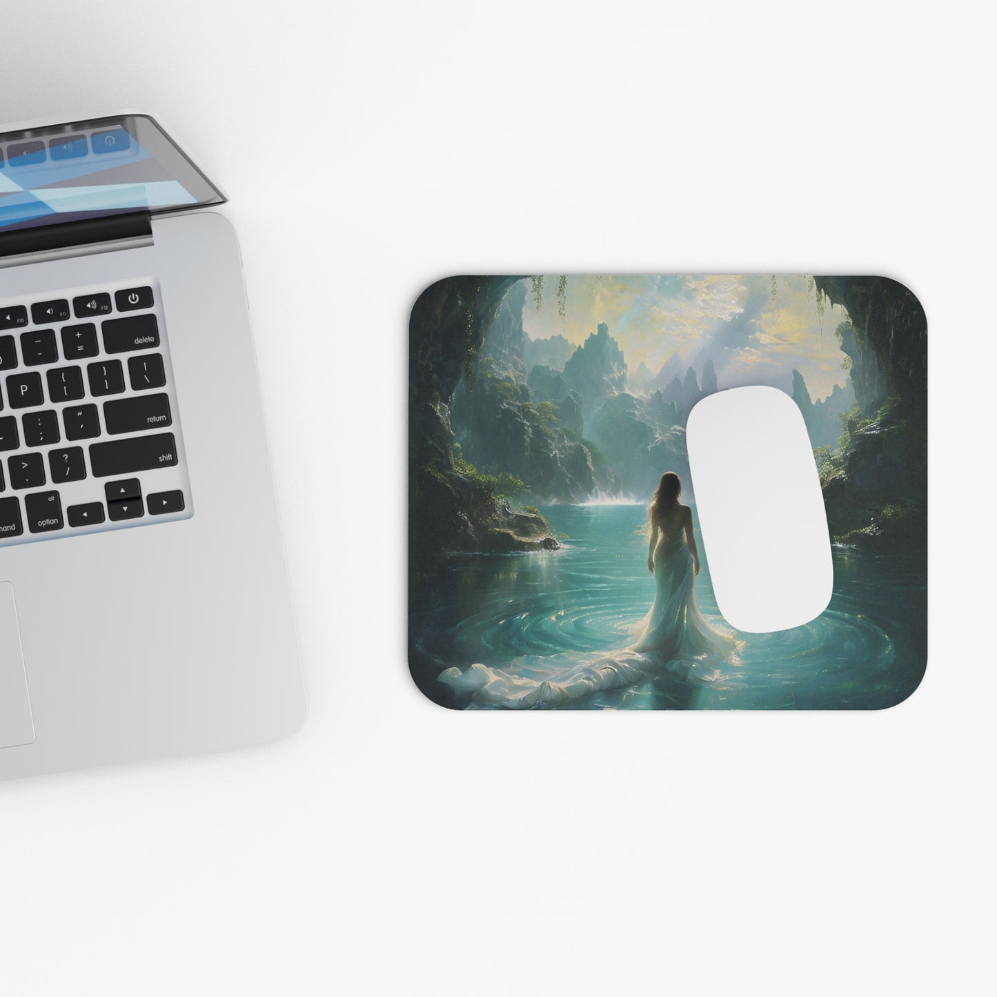 Celestial Tides mouse pad beside laptop displaying celestial ocean artwork