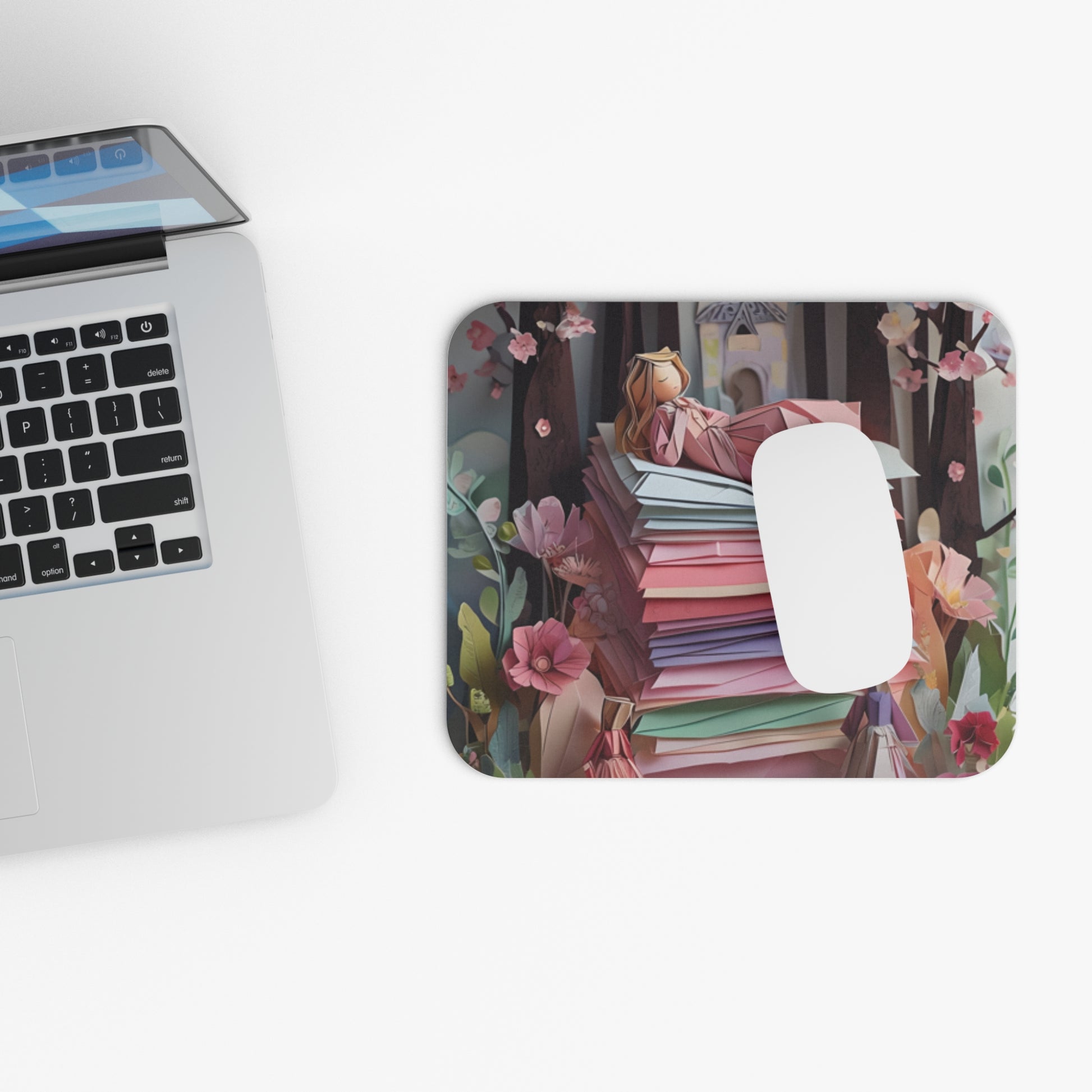 A Good Night's Sleep mouse pad beside laptop displaying colorful textile-inspired artwork