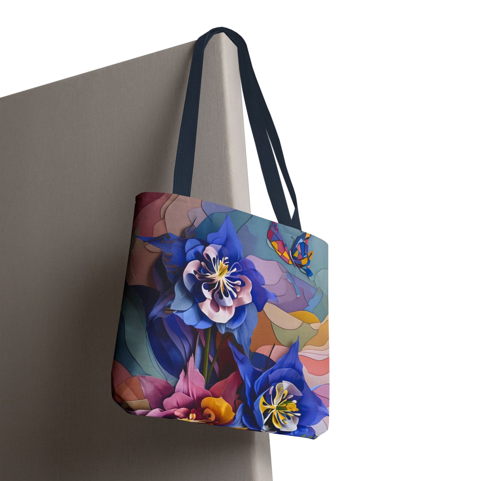 Blue Columbine Carnivale canvas tote bag hanging with vibrant blue floral carnivale artwork