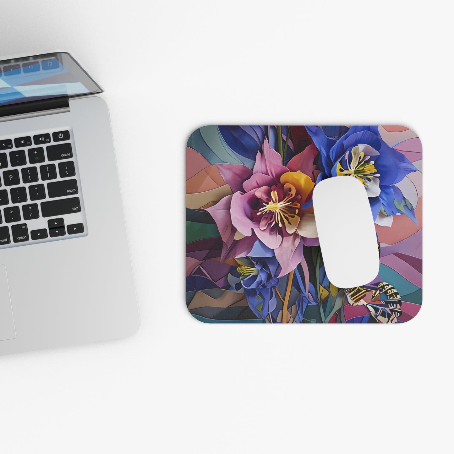 Blue Columbine Carnivale mouse pad beside laptop displaying columbine flower artwork