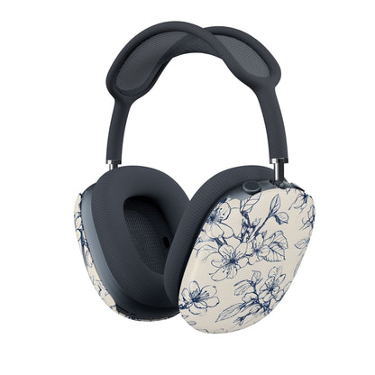Blossom Sketch AirPods Max cover with navy blue line art flowers on cream background, minimal floral pattern, angled view on Apple AirPods Max headphones