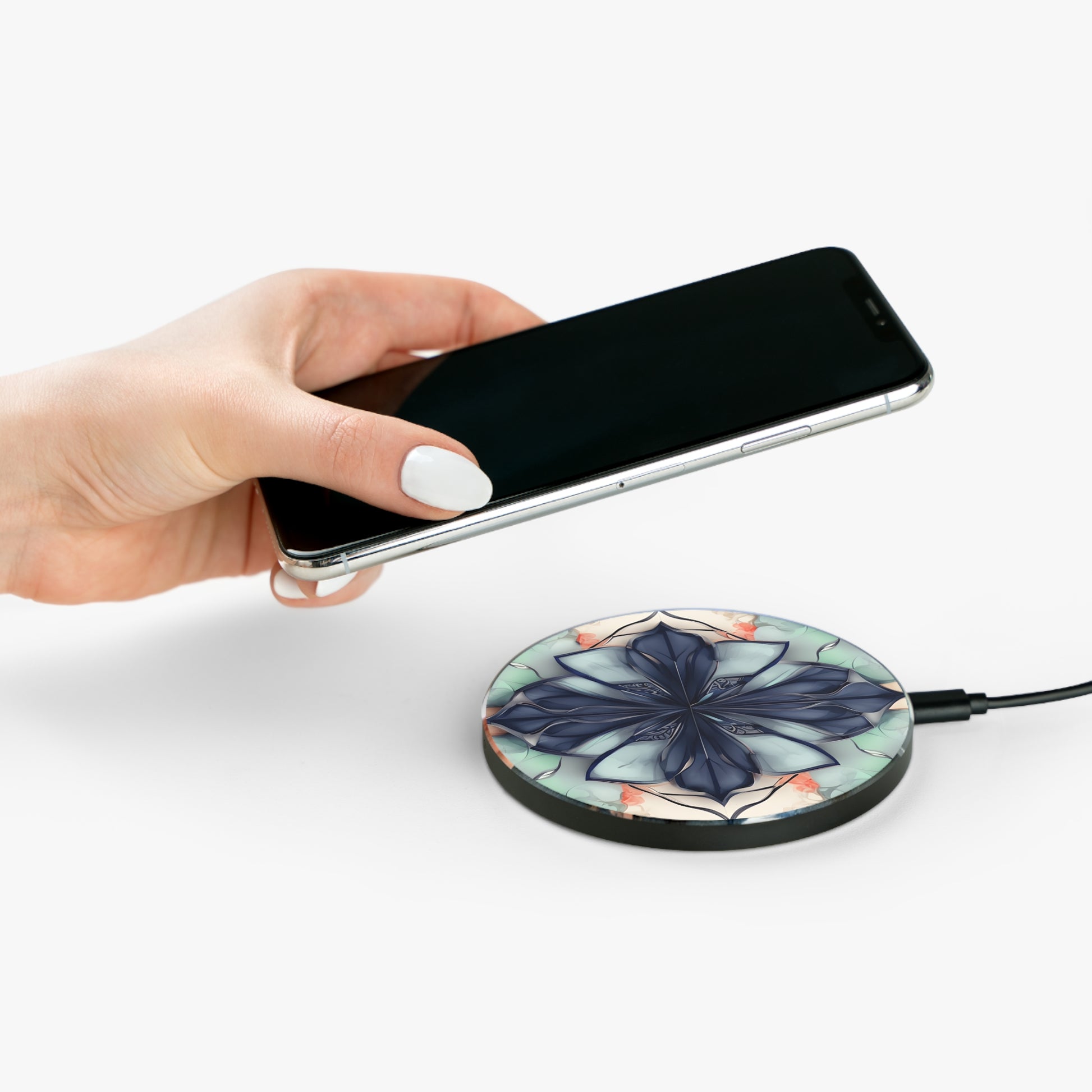 Hand placing smartphone on Midnight Mosaic blue floral mandala Qi wireless charger