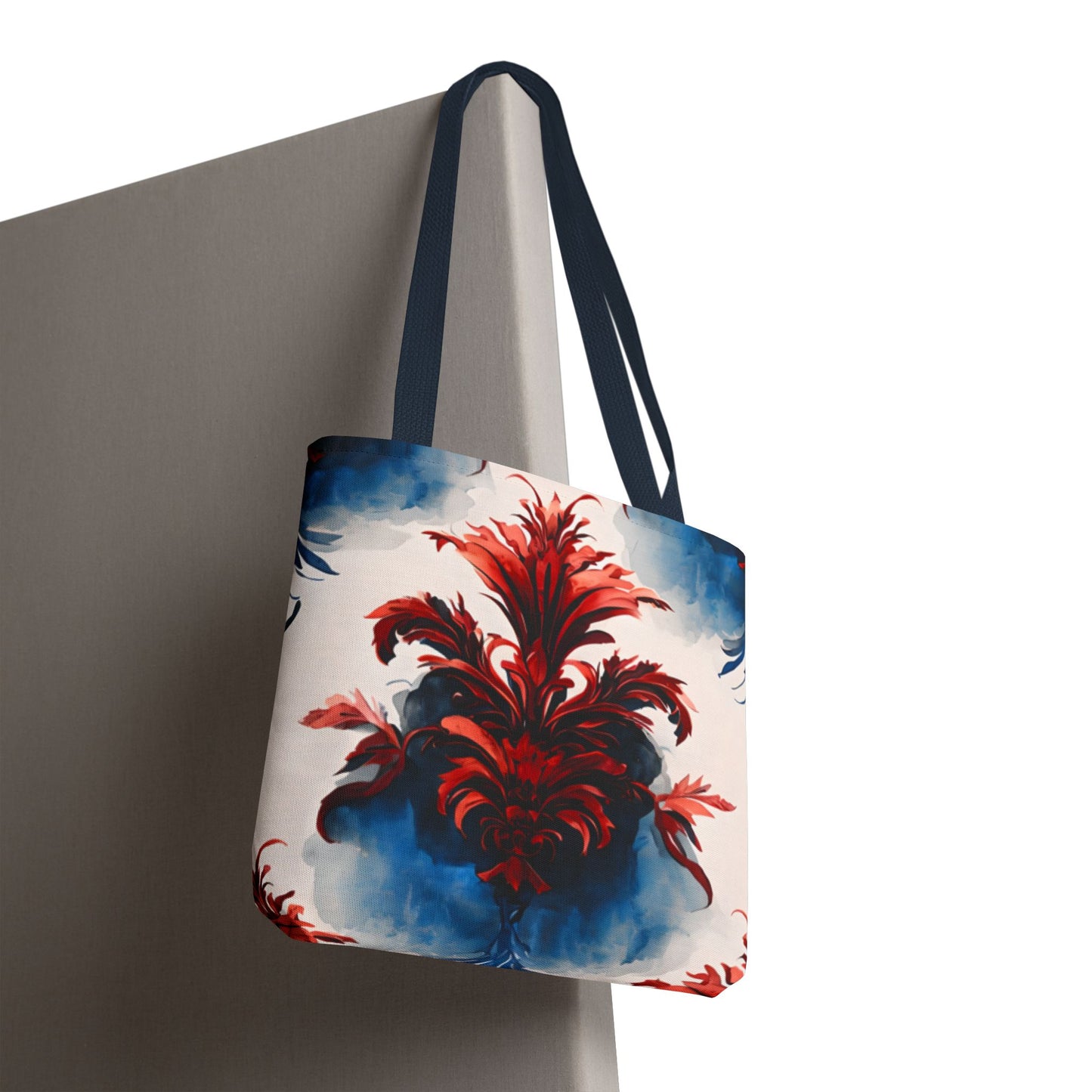 Crimson Plume canvas tote bag hanging with vibrant red abstract plume pattern