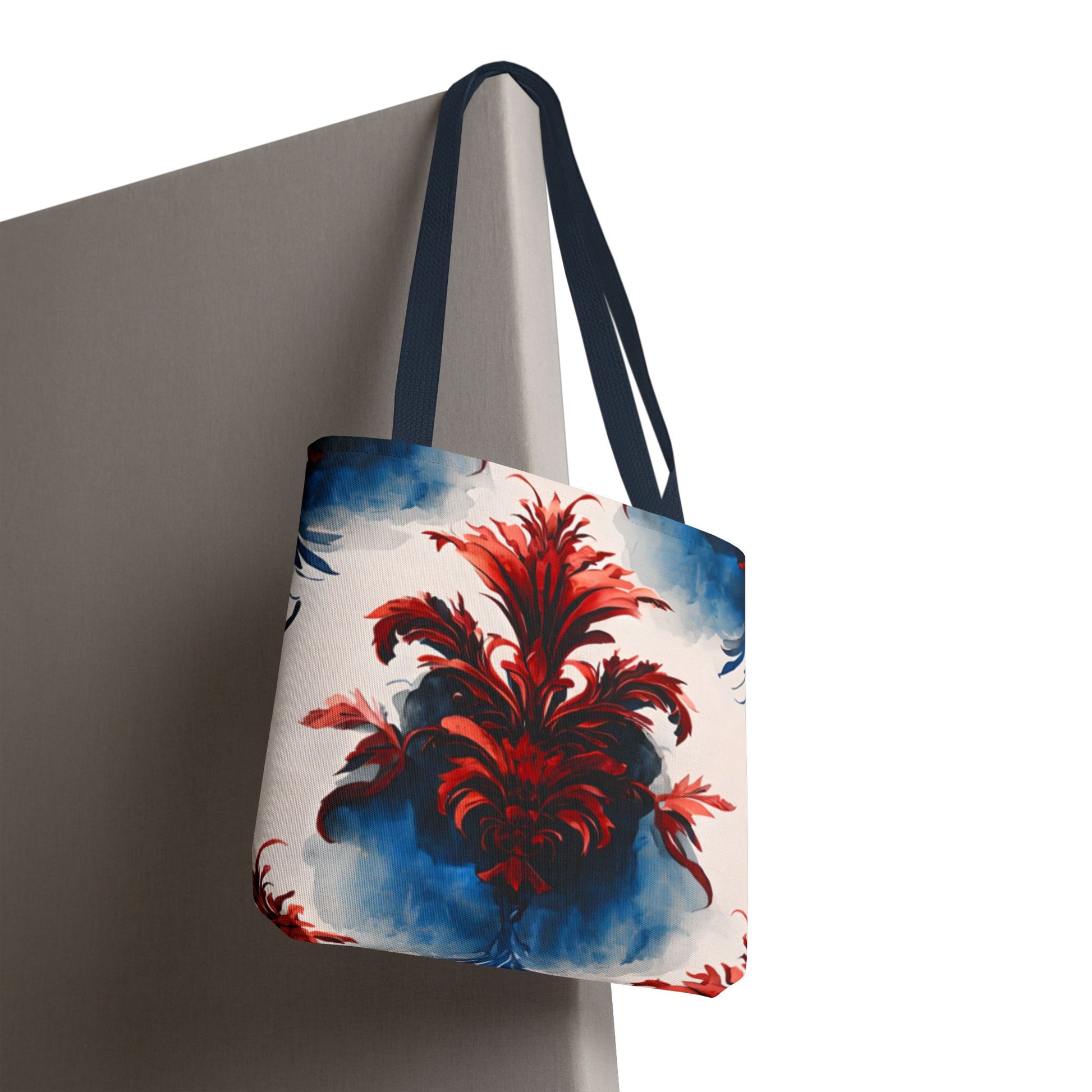 Crimson Plume canvas tote bag hanging with vibrant red abstract plume pattern
