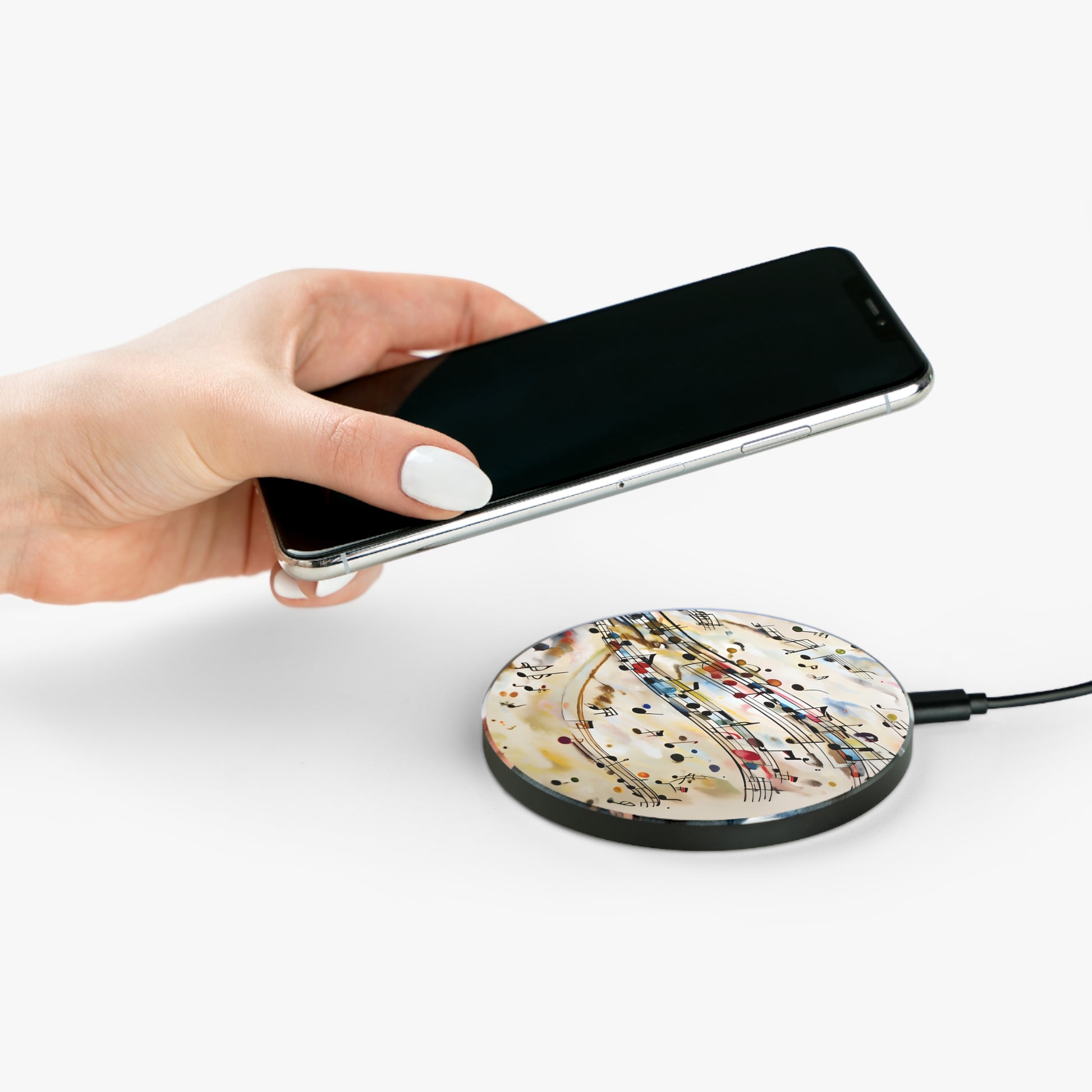 Hand placing smartphone on Melodic Flow musical notes design Qi wireless charger