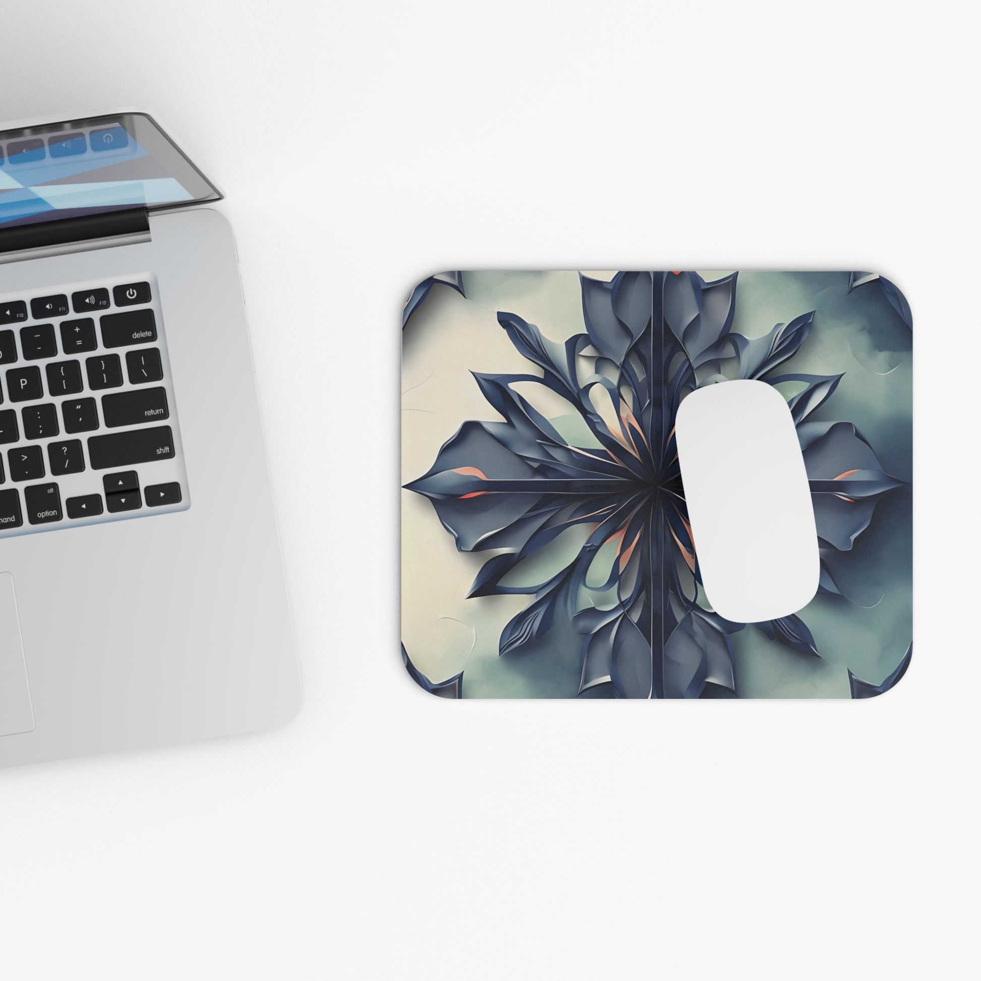 Frosted Indigo Bloom mouse pad beside laptop displaying blue floral bloom artwork
