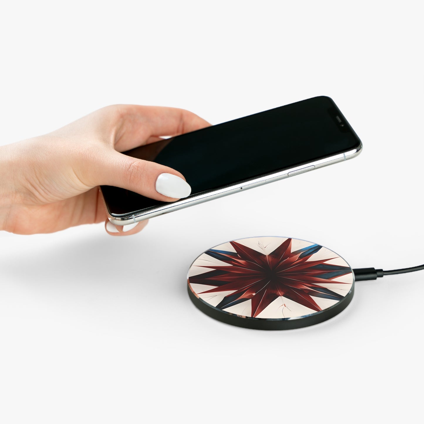 Hand placing smartphone on Garnet Starburst red, white and blue starburst design Qi wireless charger