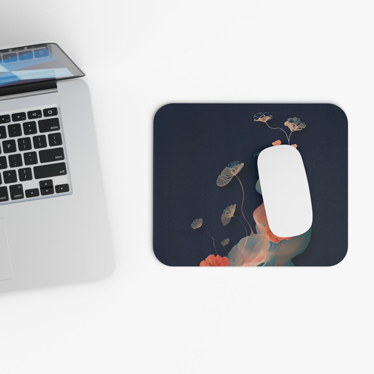 Lotus Reverie mouse pad beside laptop displaying lotus flower artwork
