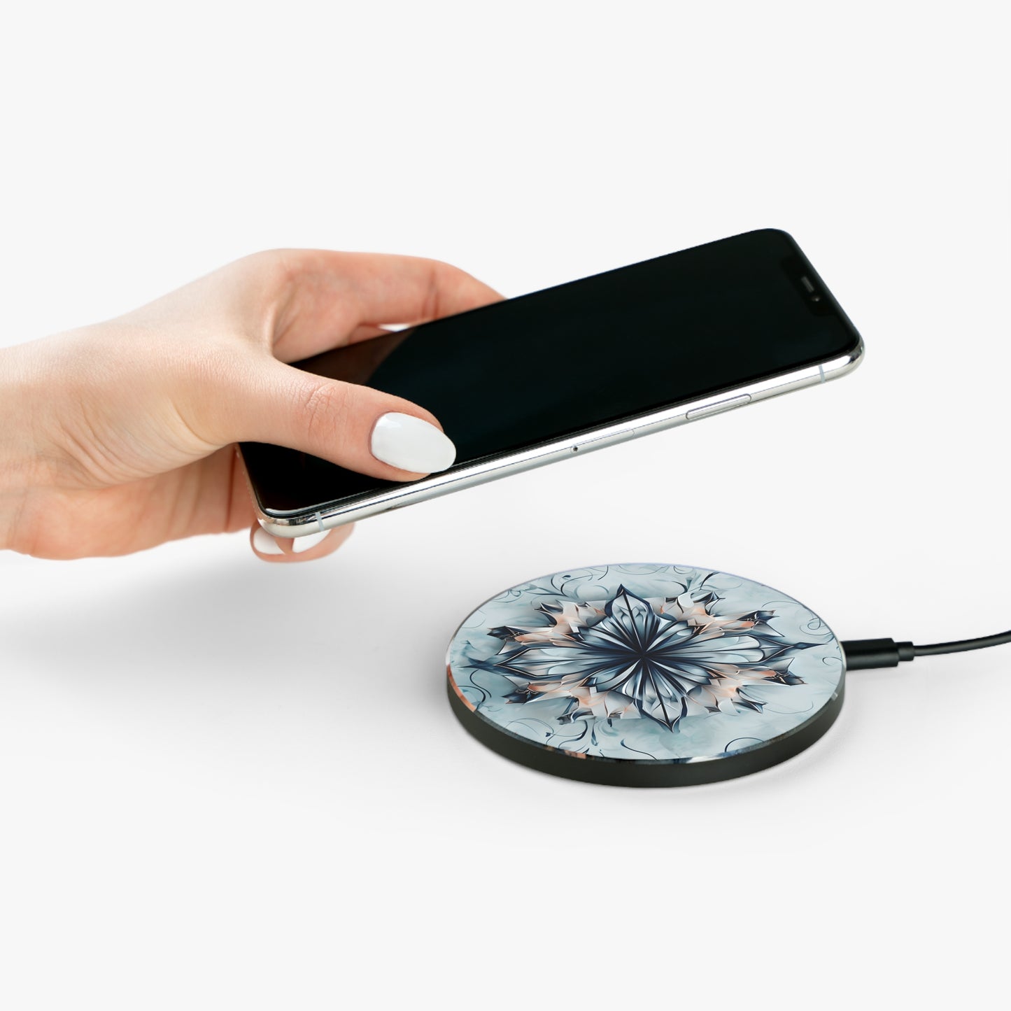 Hand placing smartphone on Indigo Mirage indigo floral mandala design Qi wireless charger