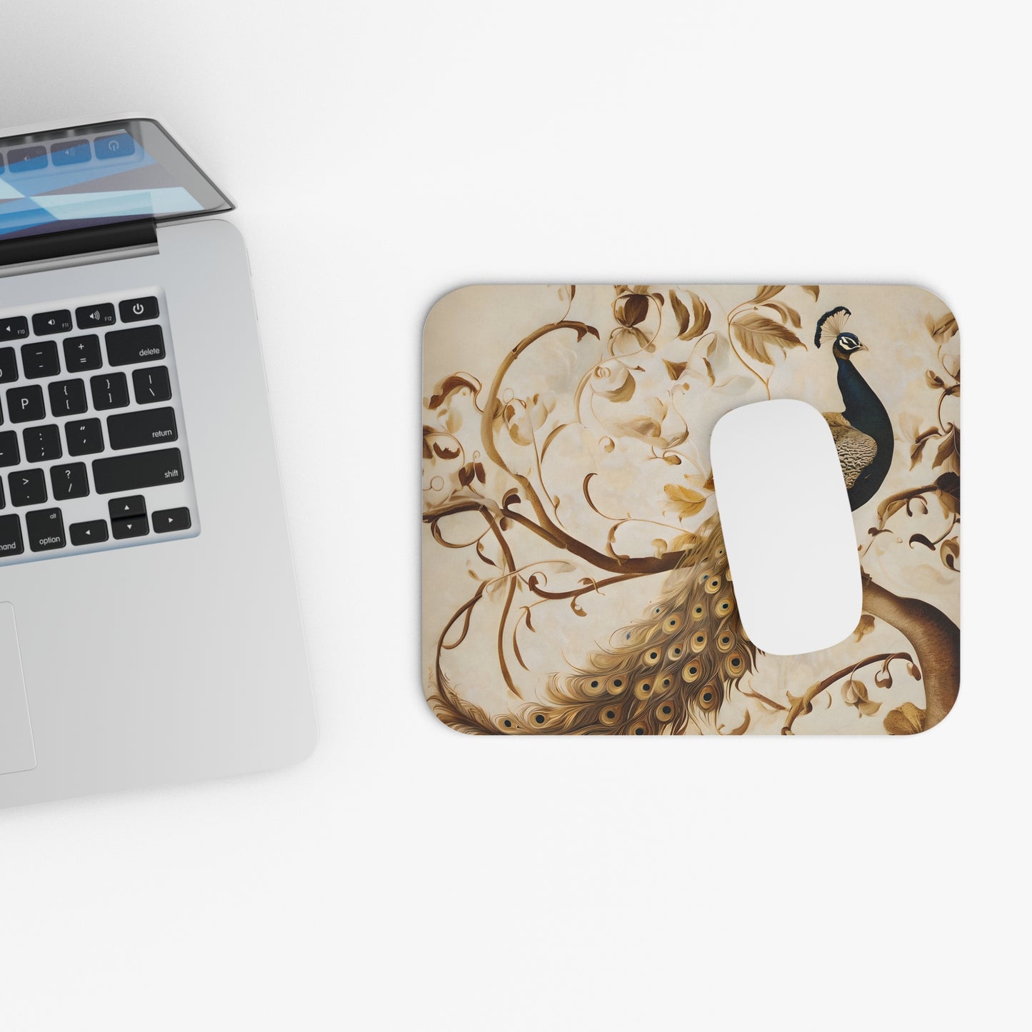 Golden Plumage mouse pad beside laptop displaying golden feather design