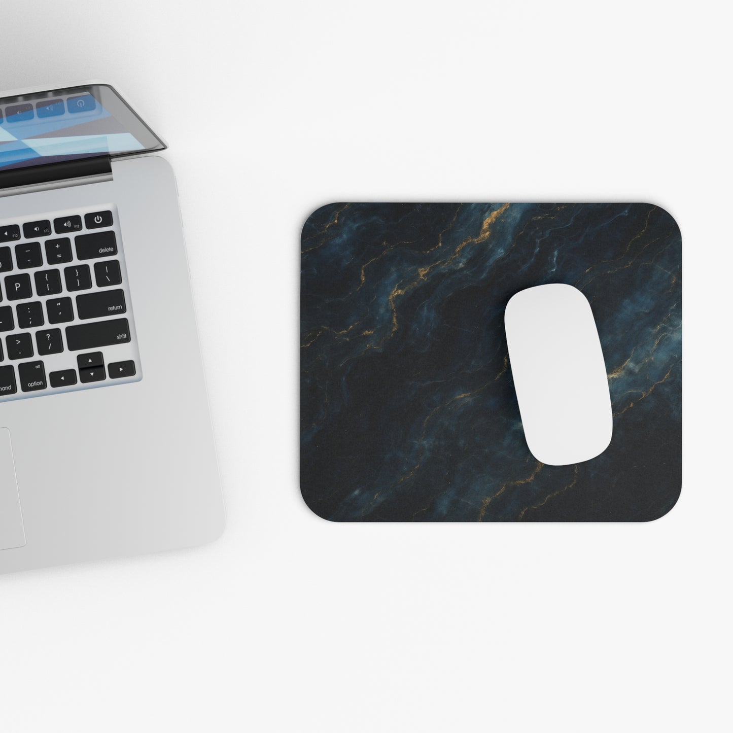 Midnight Marble mouse pad beside laptop displaying midnight marble design