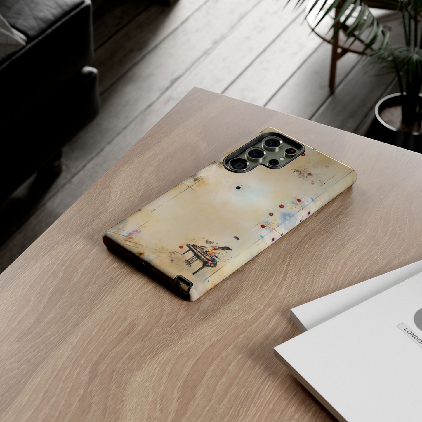 Keys of Imagination Samsung Galaxy piano phone case on wooden desk beside laptop and notebook, creative lifestyle flat lay