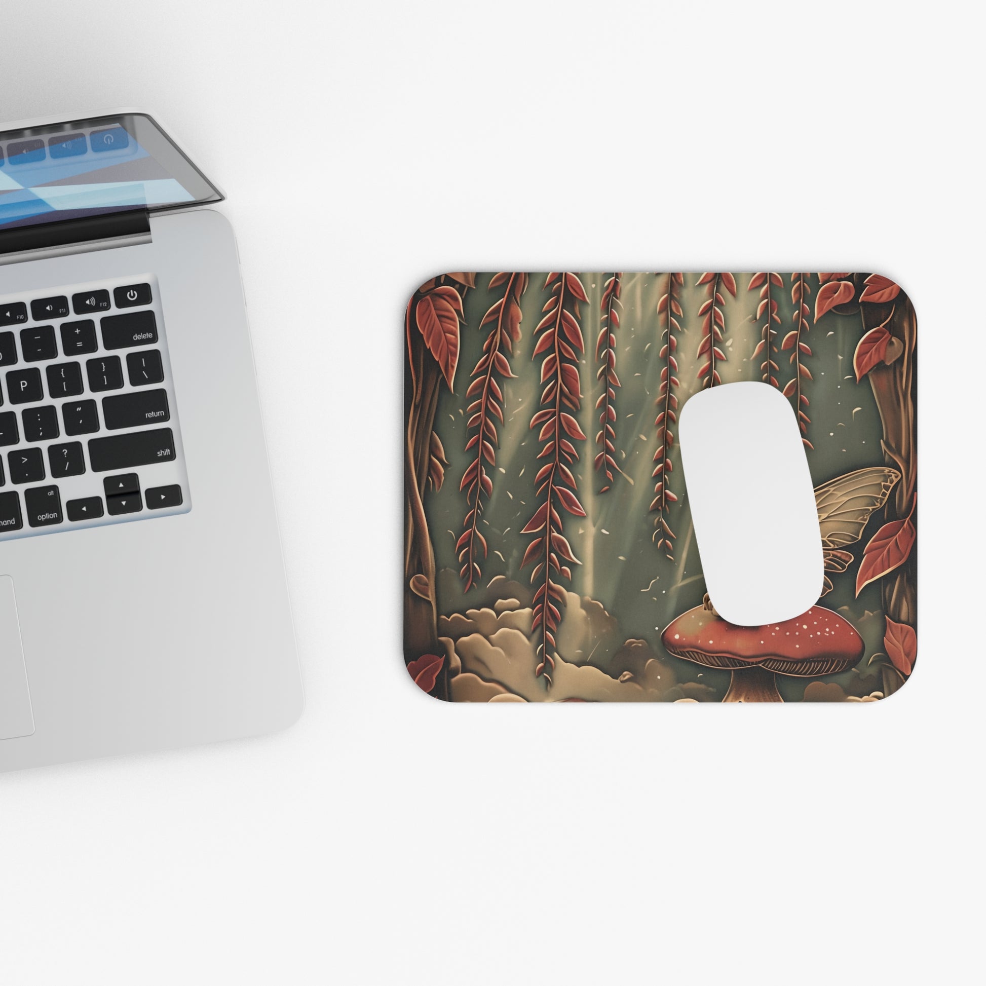 Willow Whisper mouse pad beside laptop displaying woodland botanical artwork
