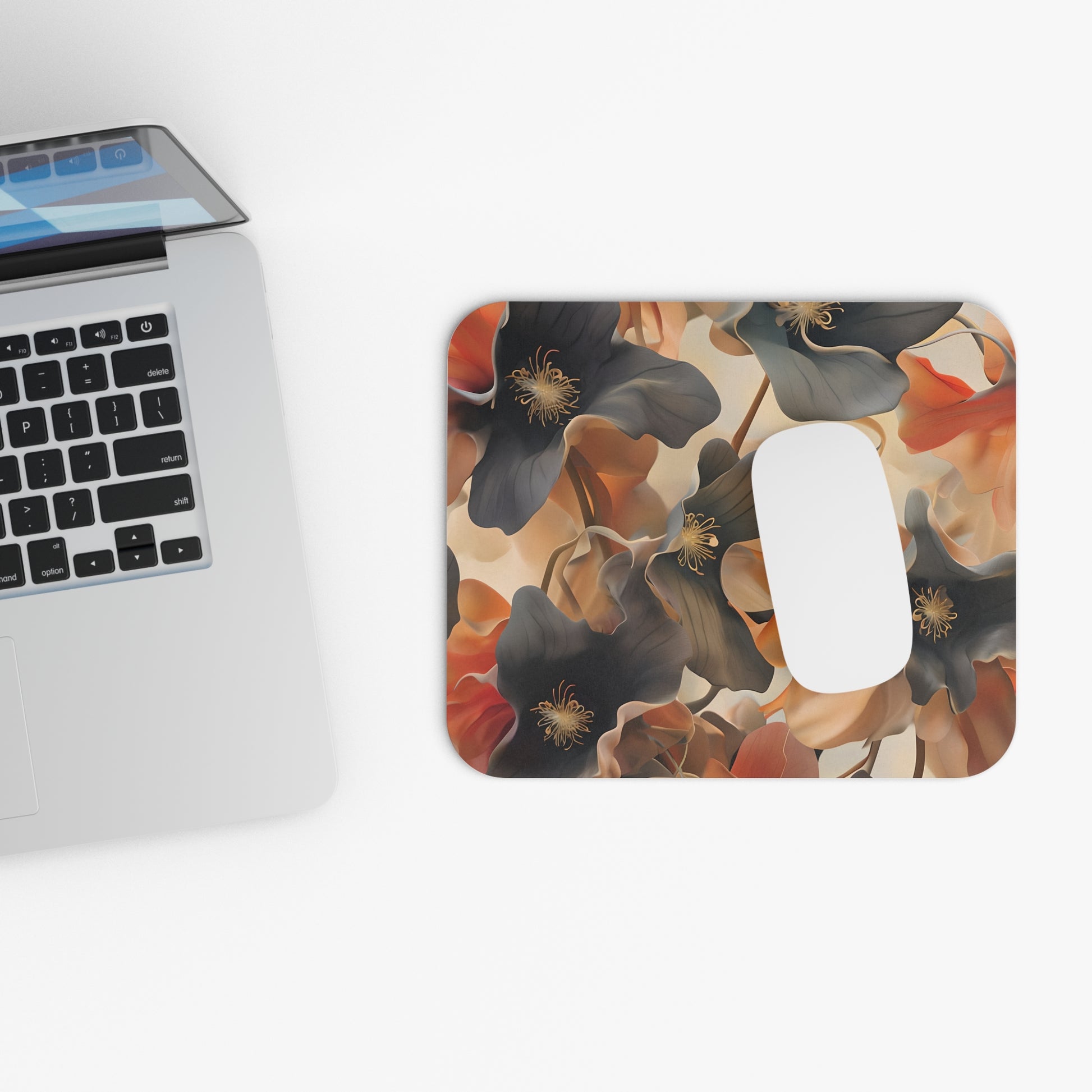 Autumn Ember mouse pad beside laptop displaying autumn floral artwork