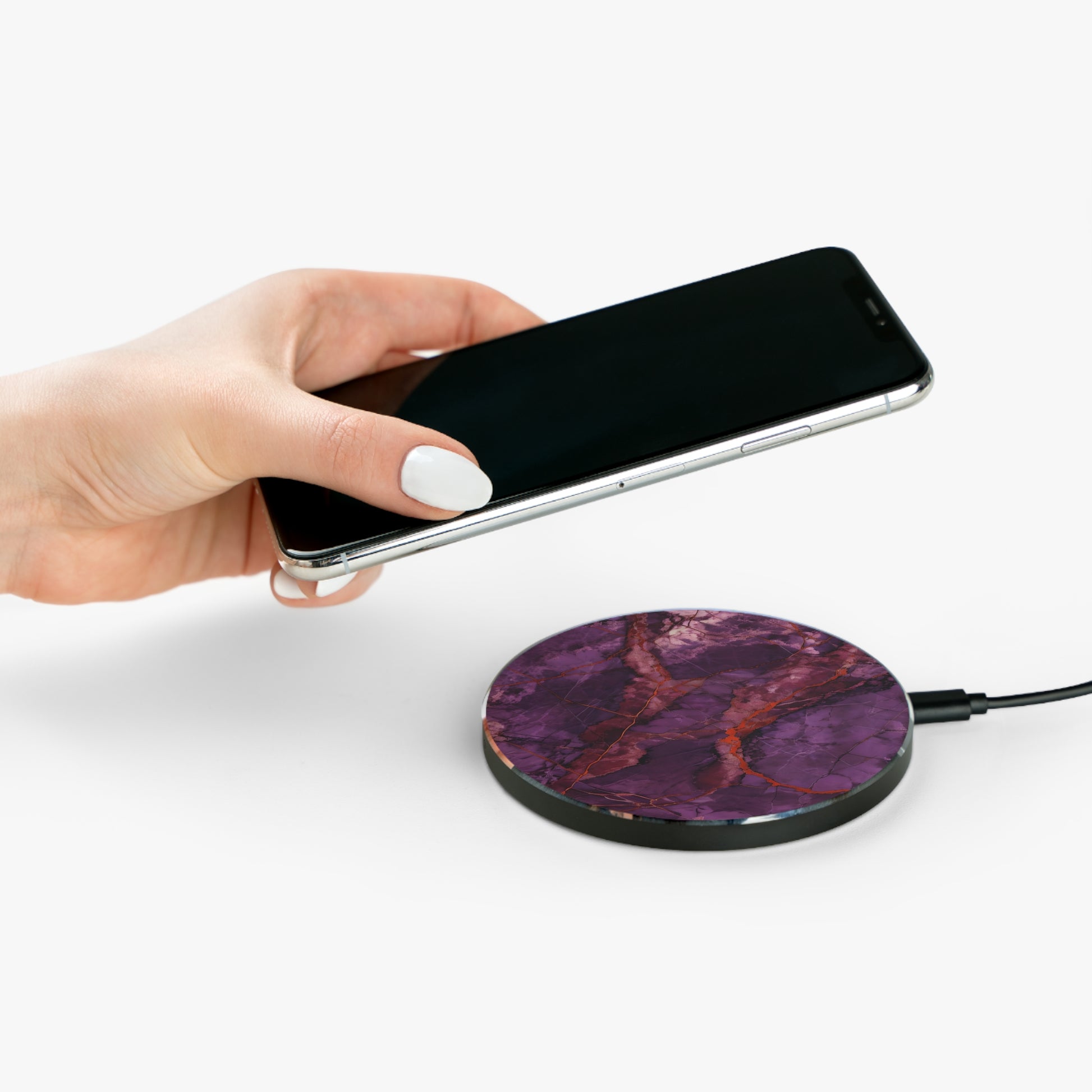 Hand placing smartphone on Amethyst Current purple marble red vein design Qi wireless charger