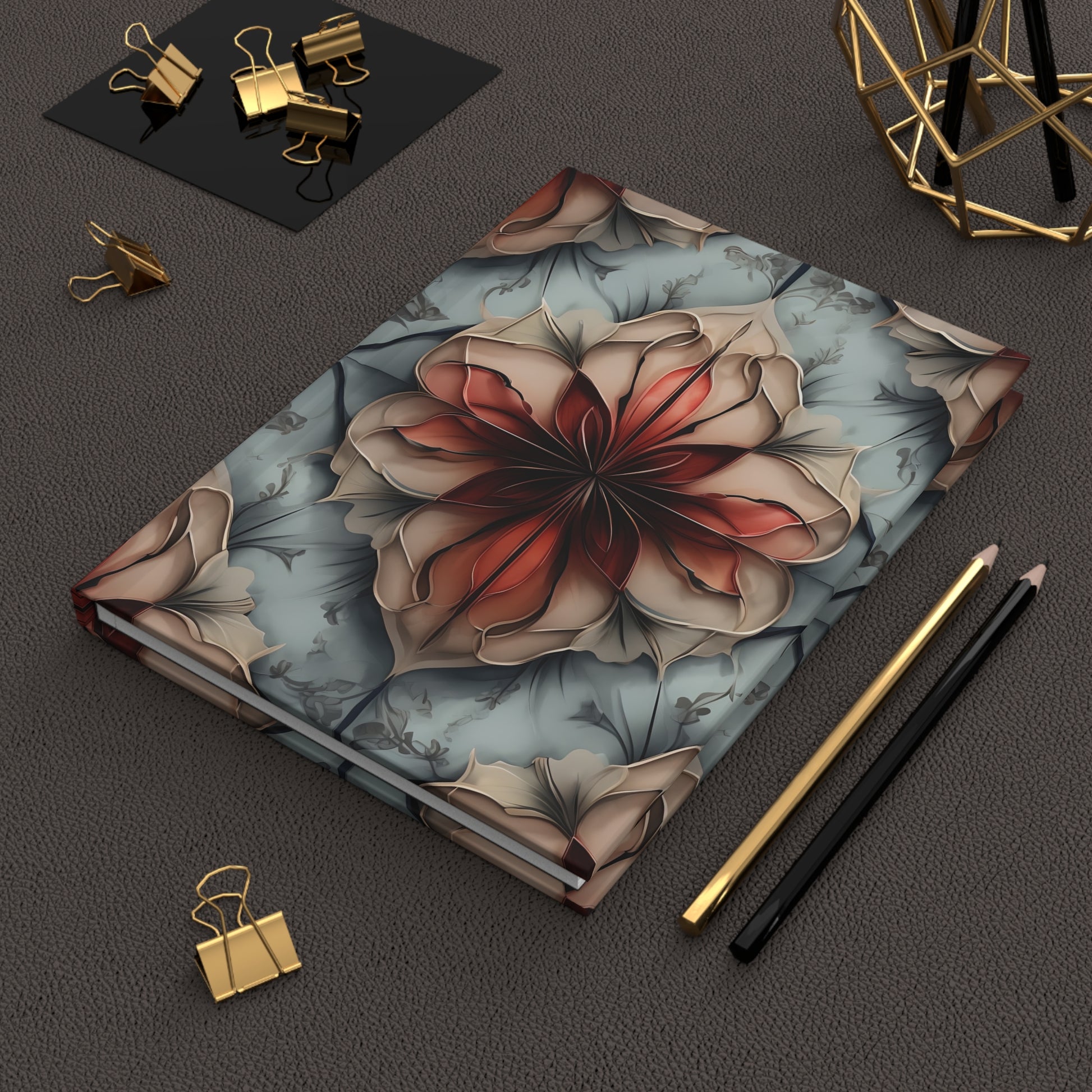 Ember Bloom hardcover journal on desk with pencils and stationery