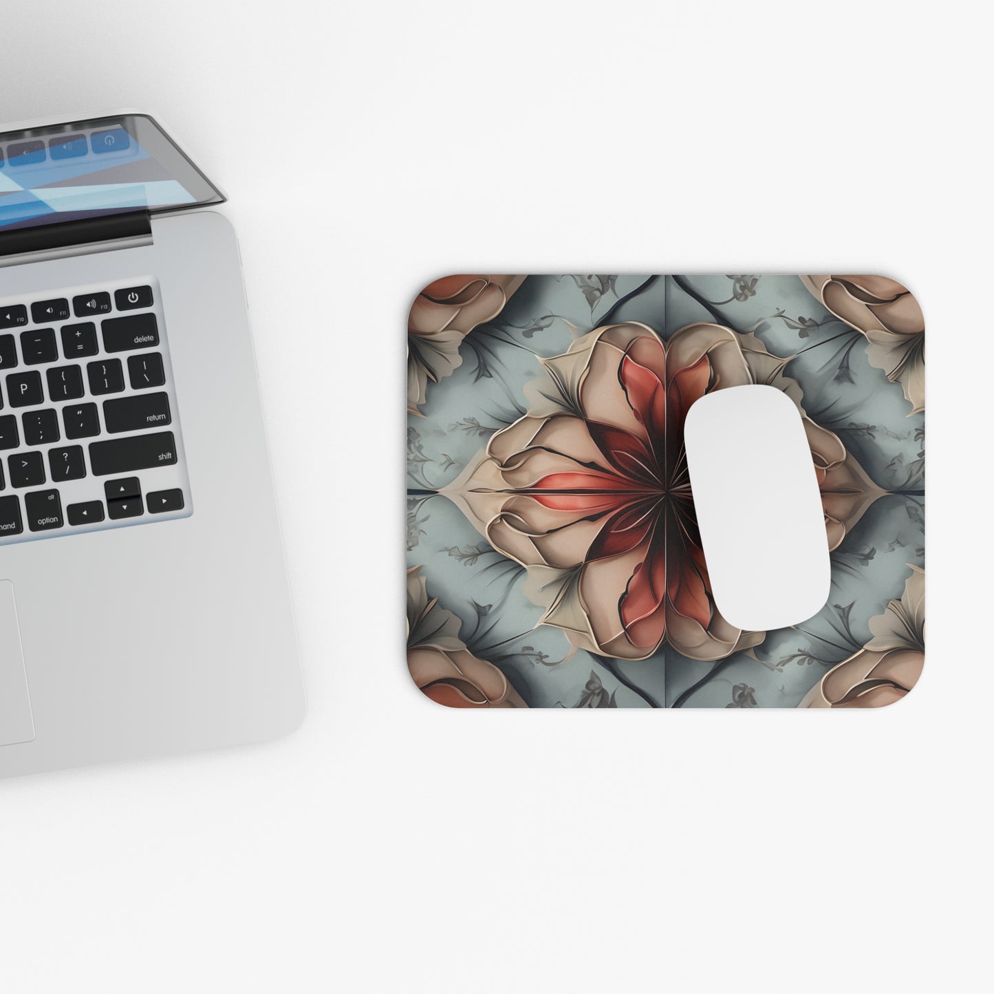 Ember Bloom mouse pad beside laptop displaying red floral bloom artwork