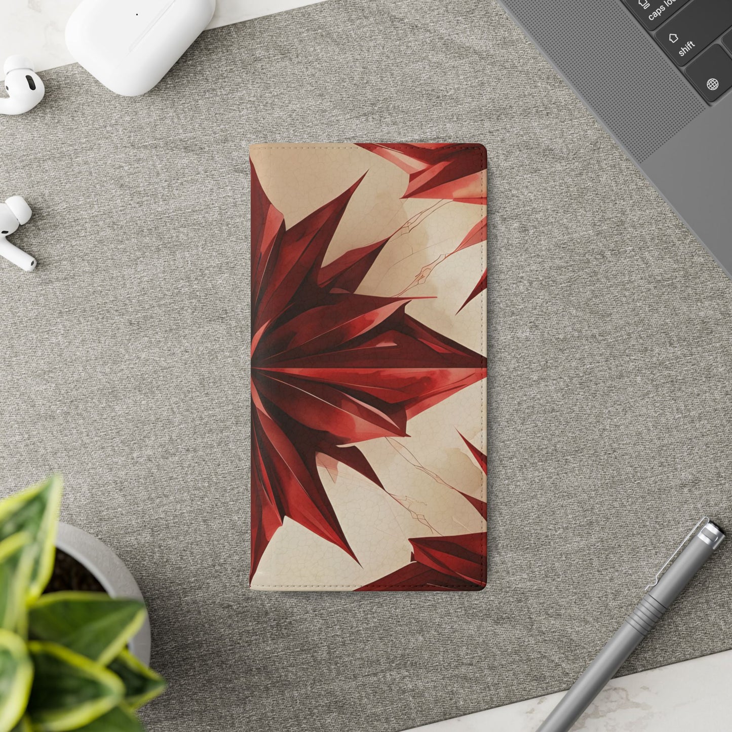 Ruby Compass Samsung Galaxy wallet flip phone case on a desk beside stationery featuring red geometric starburst design and folio card holder