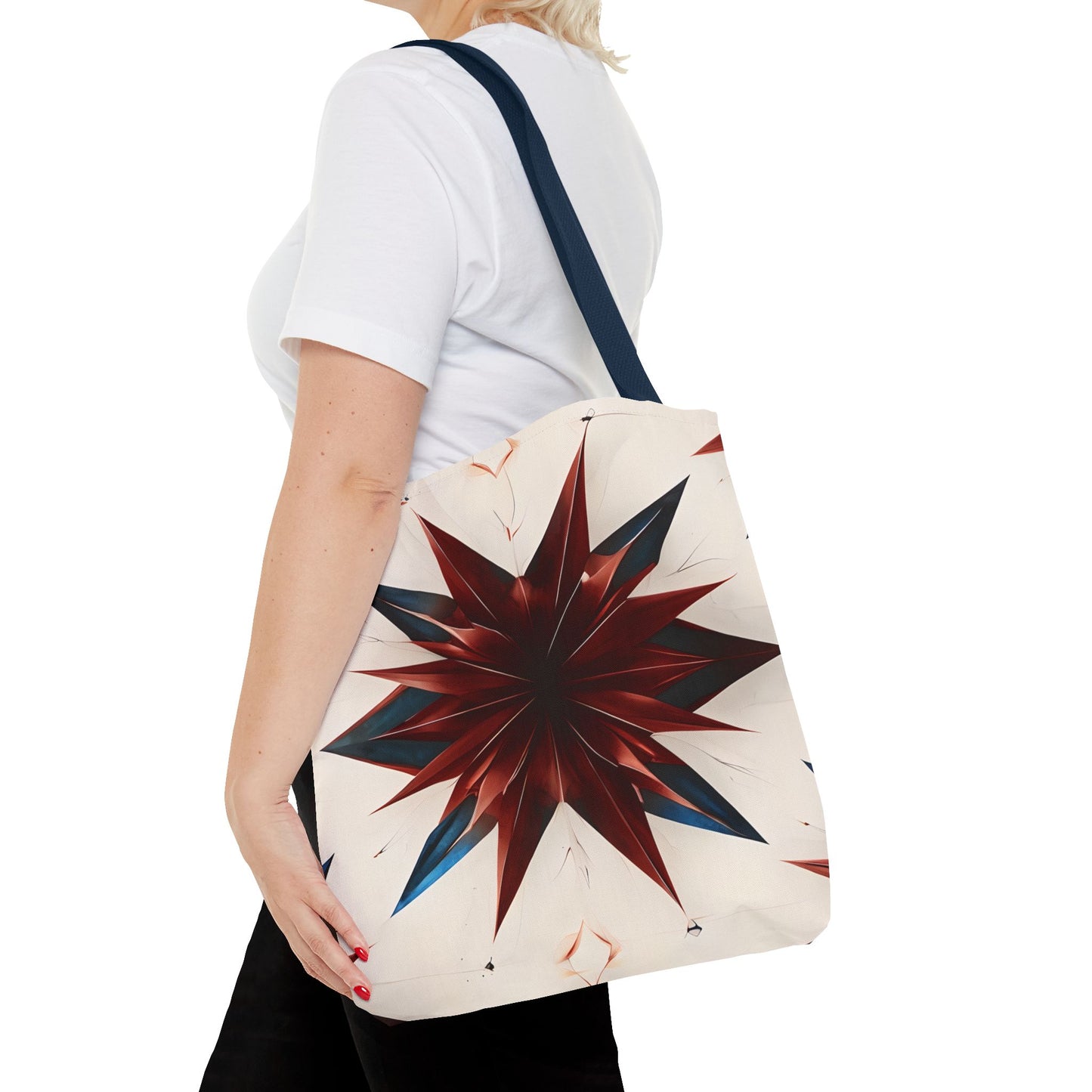 Garnet Starburst canvas tote bag worn over shoulder displaying bold garnet starburst artwork