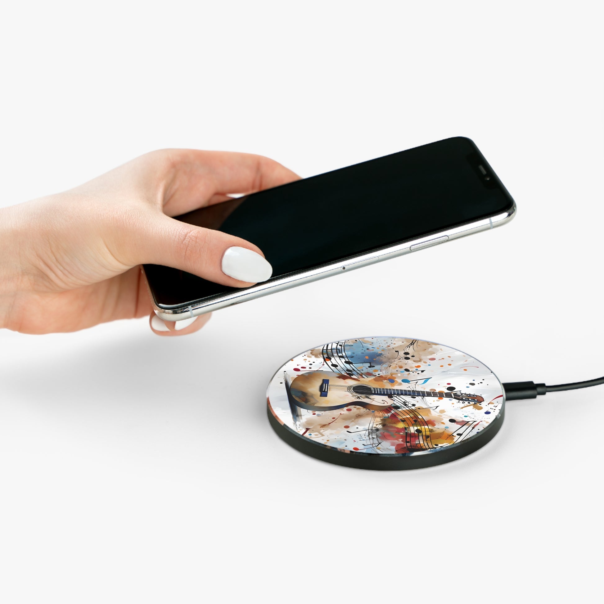 Hand placing smartphone on Strum and Flow acoustic guitar music design Qi wireless charger