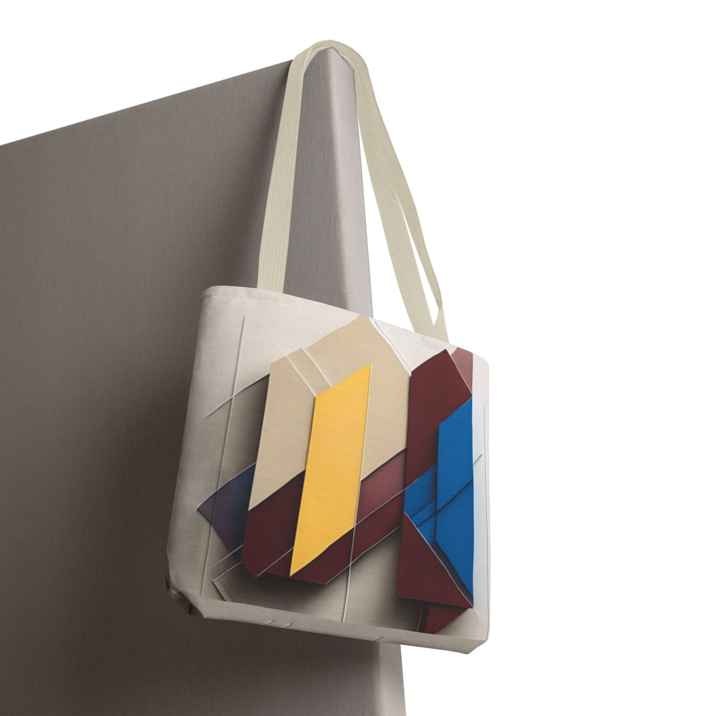 Chromatic Construct canvas tote bag hanging with vibrant color-block geometric design
