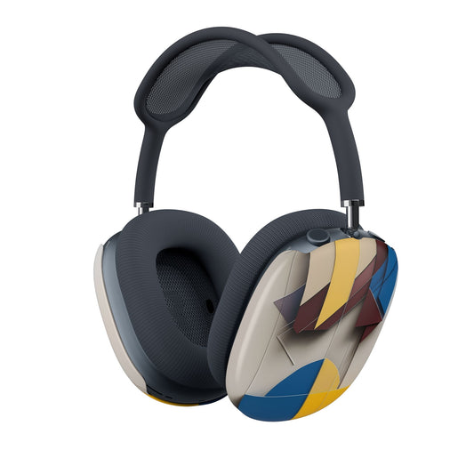 Chromatic Construct AirPods Max cover with layered geometric shapes in mustard yellow, deep blue, and burgundy on warm beige, angled view on Apple AirPods Max headphones