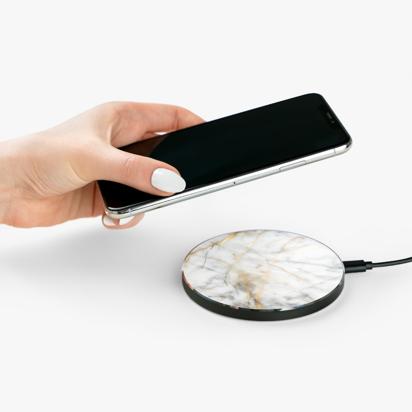 Hand placing smartphone on Golden Vein white marble gold vein design Qi wireless charger