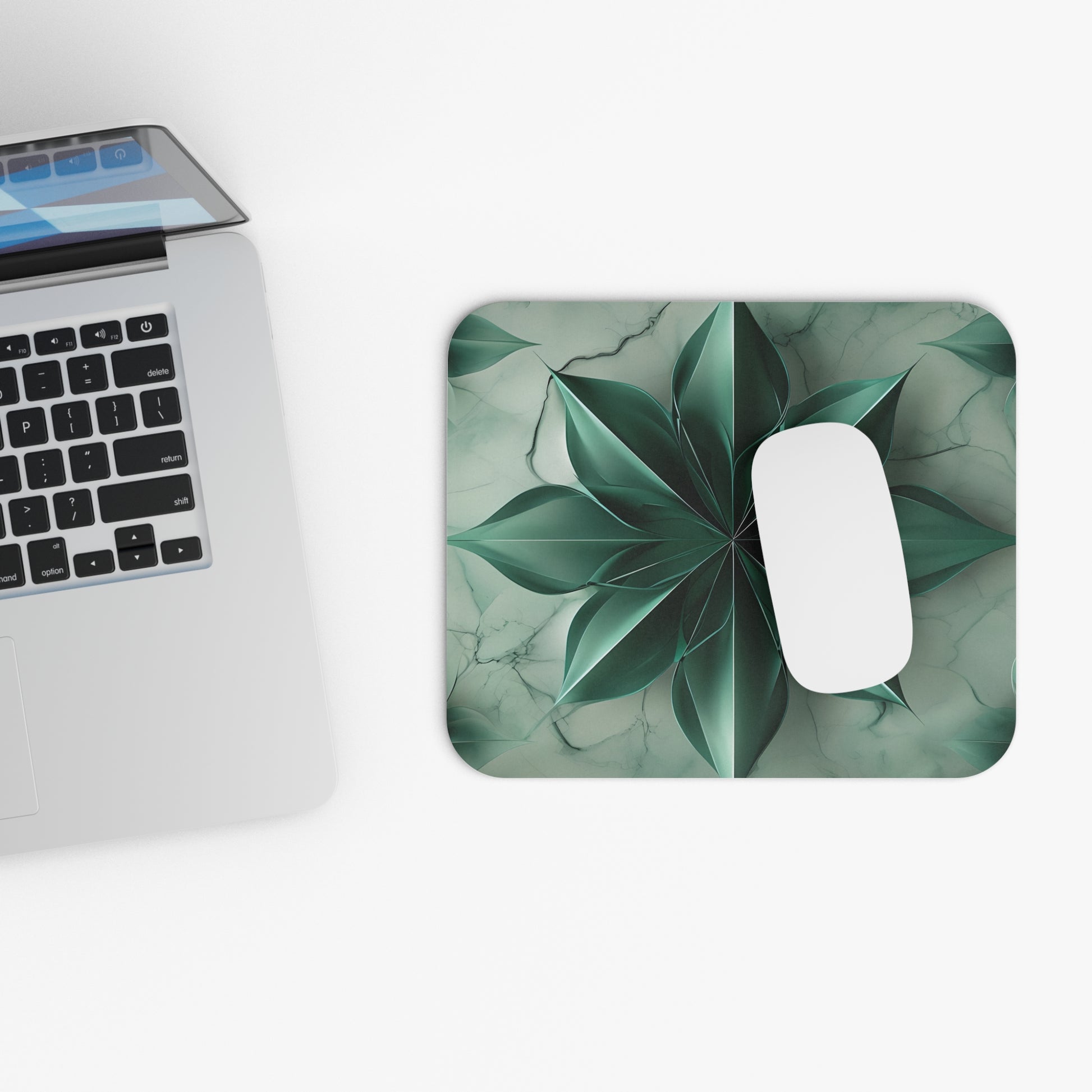 Emerald Bloom mouse pad beside laptop displaying green floral design