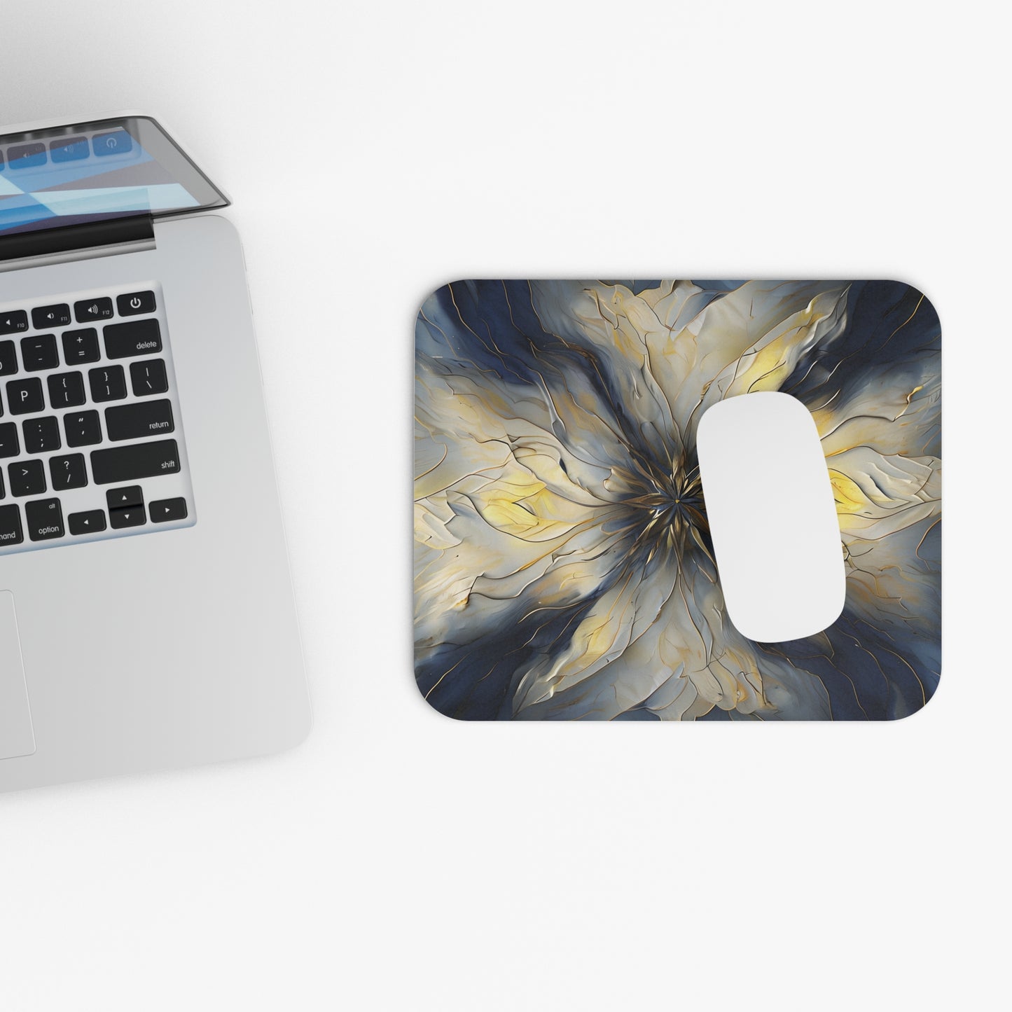 Luminous Petal mouse pad beside laptop displaying golden mandala design