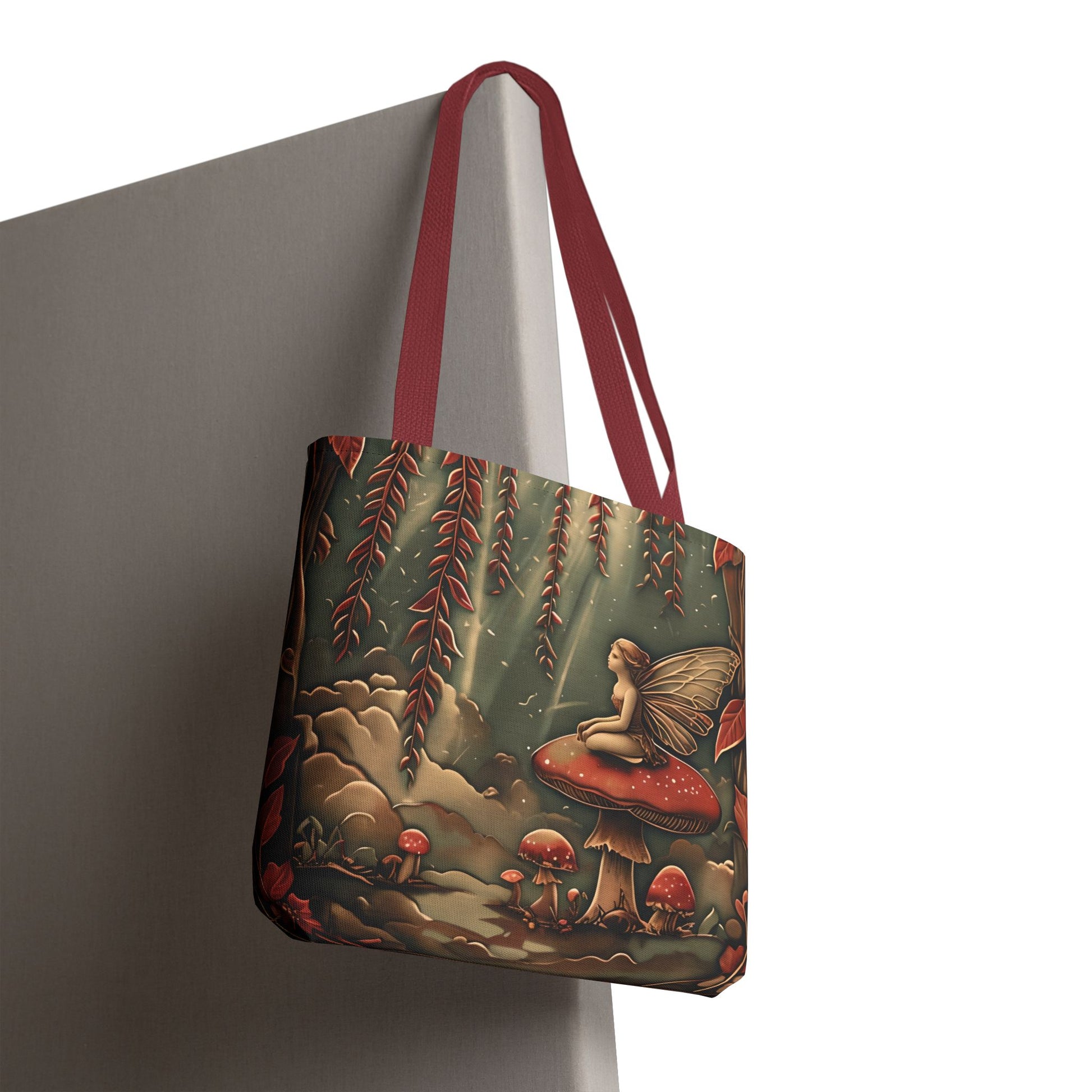 Willow Whisper canvas tote bag hanging with a fairy and mushrooms with red handles.