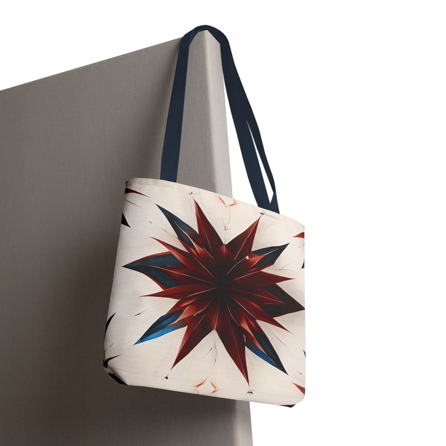 Garnet Starburst canvas tote bag hanging with vibrant red starburst geometric pattern