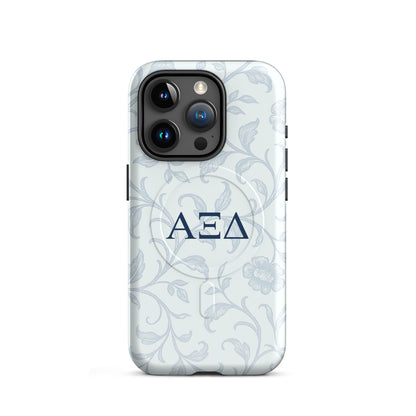 Alpha Xi Delta iPhone 15 Pro case with blue floral toile design and Greek letters, slim durable cover with MagSafe compatibility
