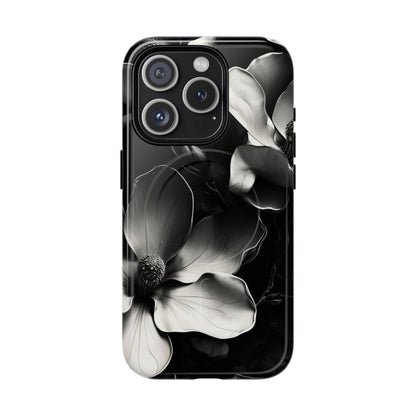 Monochrome Magnolia black and white floral iPhone 15 Pro MagSafe case featuring elegant magnolia blossoms on a dramatic dark background.