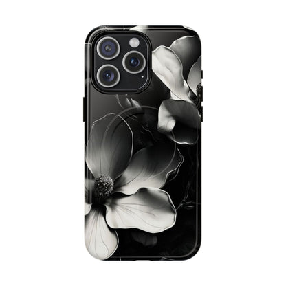 Monochrome Magnolia black and white floral iPhone 15 Pro Max MagSafe case featuring elegant magnolia blossoms on a dramatic dark background.